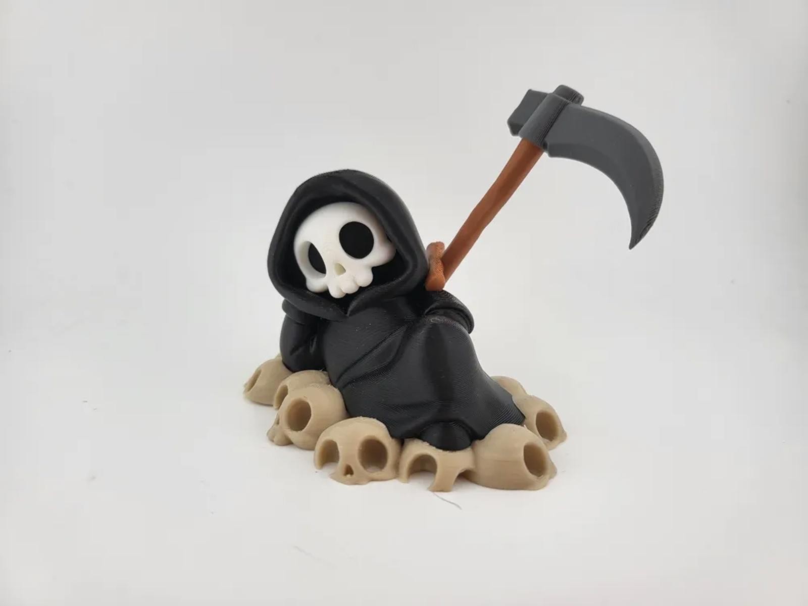 Chillin&rsquo; Grim Reaper Skeleton Figure on Skull Pile