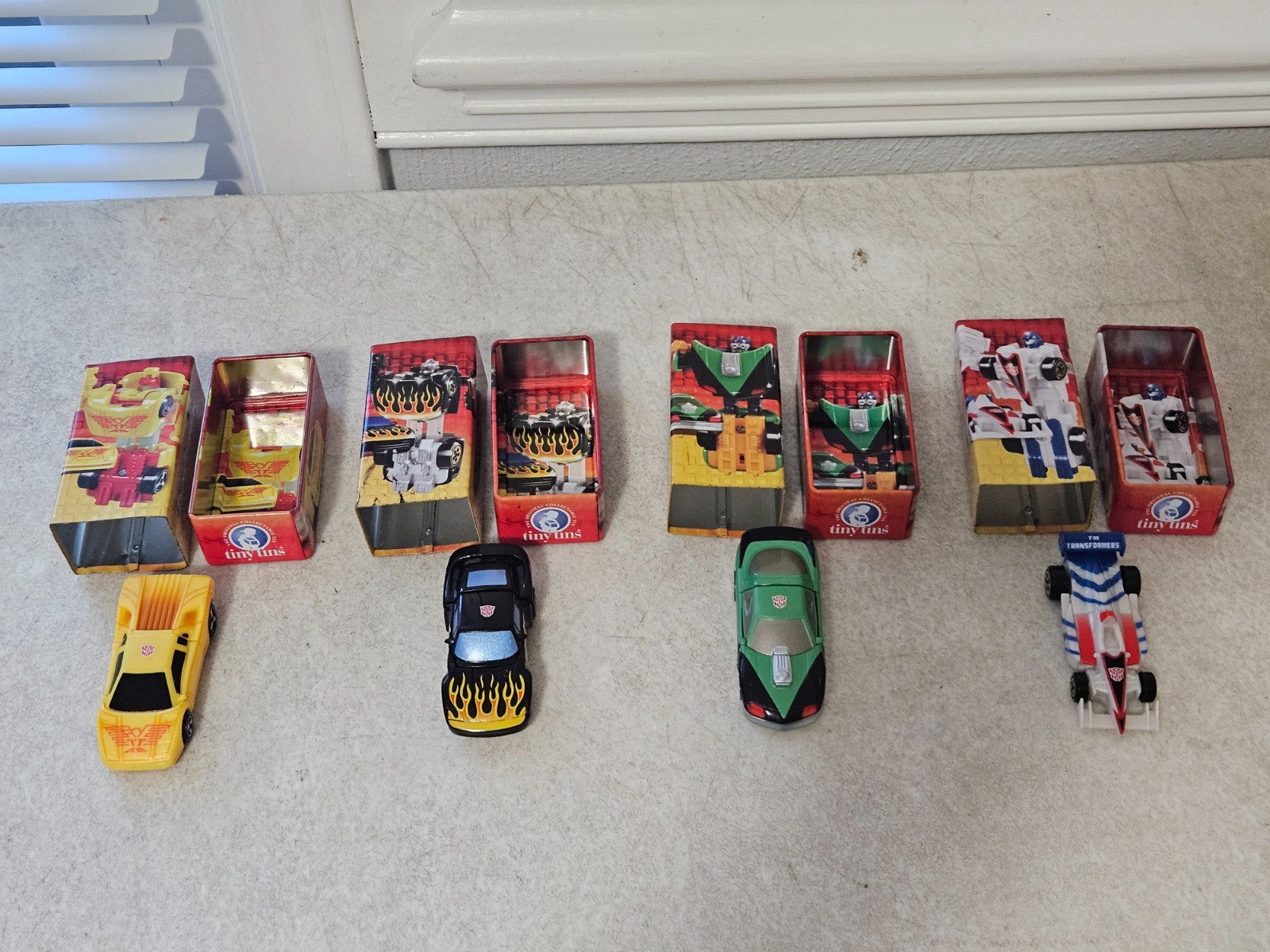 VINTAGE TRANSFORMERS TINY TINS LOT OF 4 SIDE SWIPE HOT SHOT MIRAGE R.E.V.