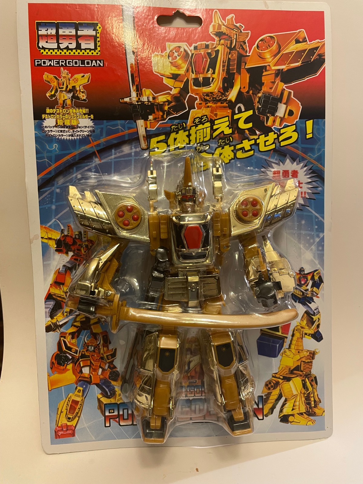 Transformers robot toy the figure is gold -colored with Silver and red accents