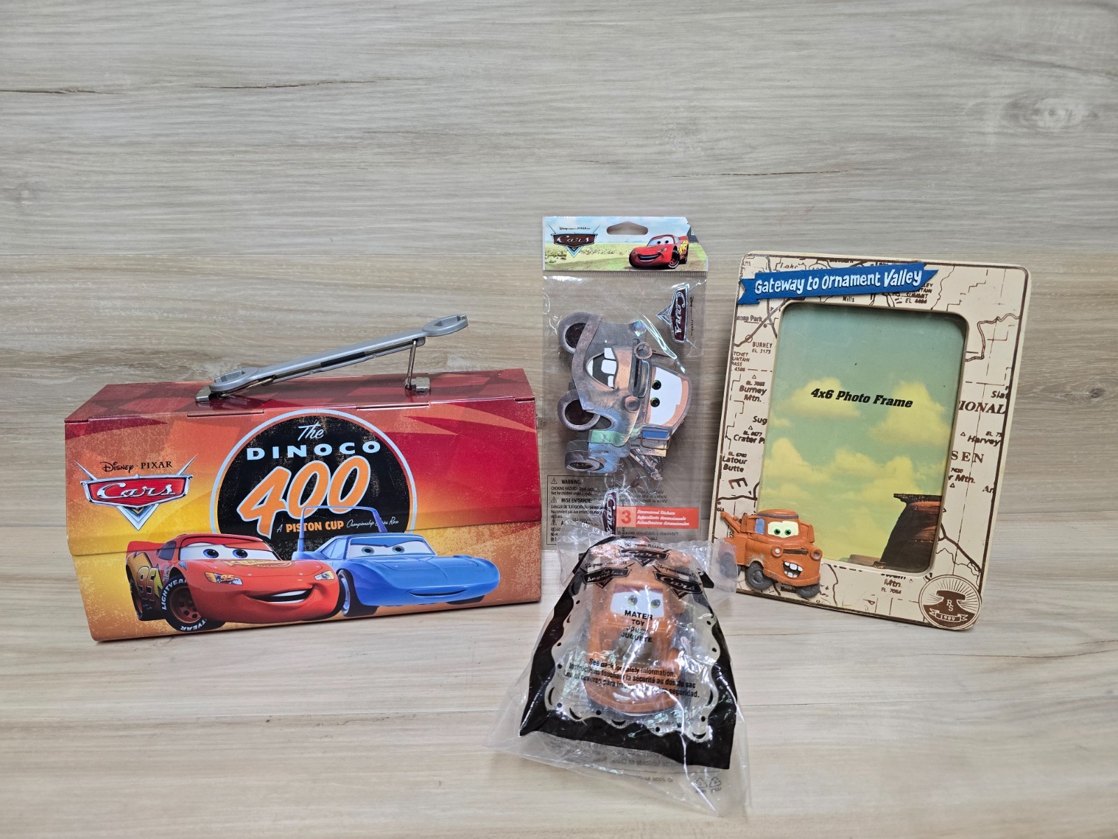 4 Disney Pixar Cars items 1 Tin Box,1 Sticker, 1 Picture Frame & 1 Mcdonalds Toy