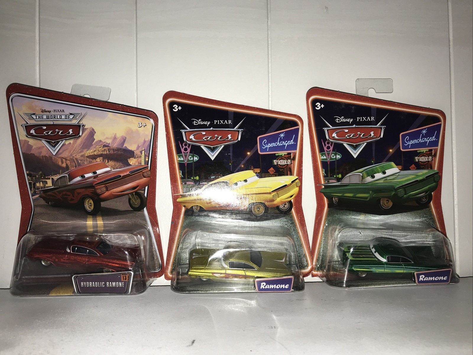 Three Disney Pixar Cars Ramone Figures In Red #13, Yellow, And Green in Packages